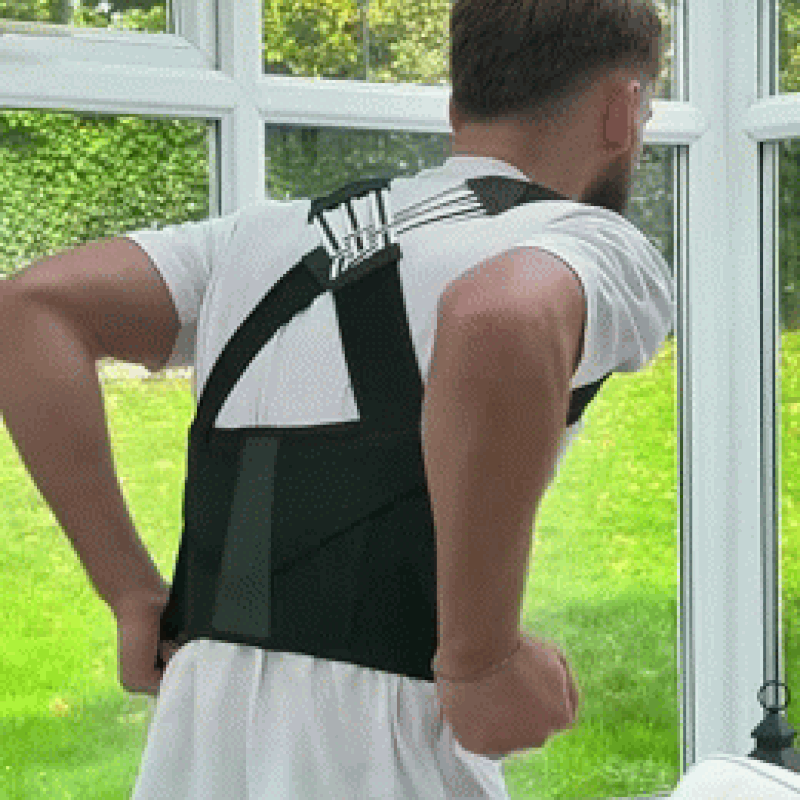 Person wearing the posture support brace, showing its crossed back straps and waist wrap